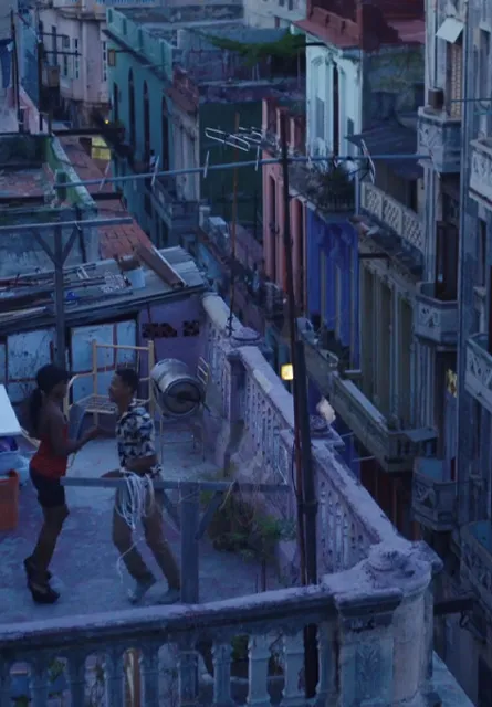 FILM CUBA | Young couple dancing in a rooftop of Old Havana. Sorrounded by buildings in bad condition. A blue mood dusk sets the tone.